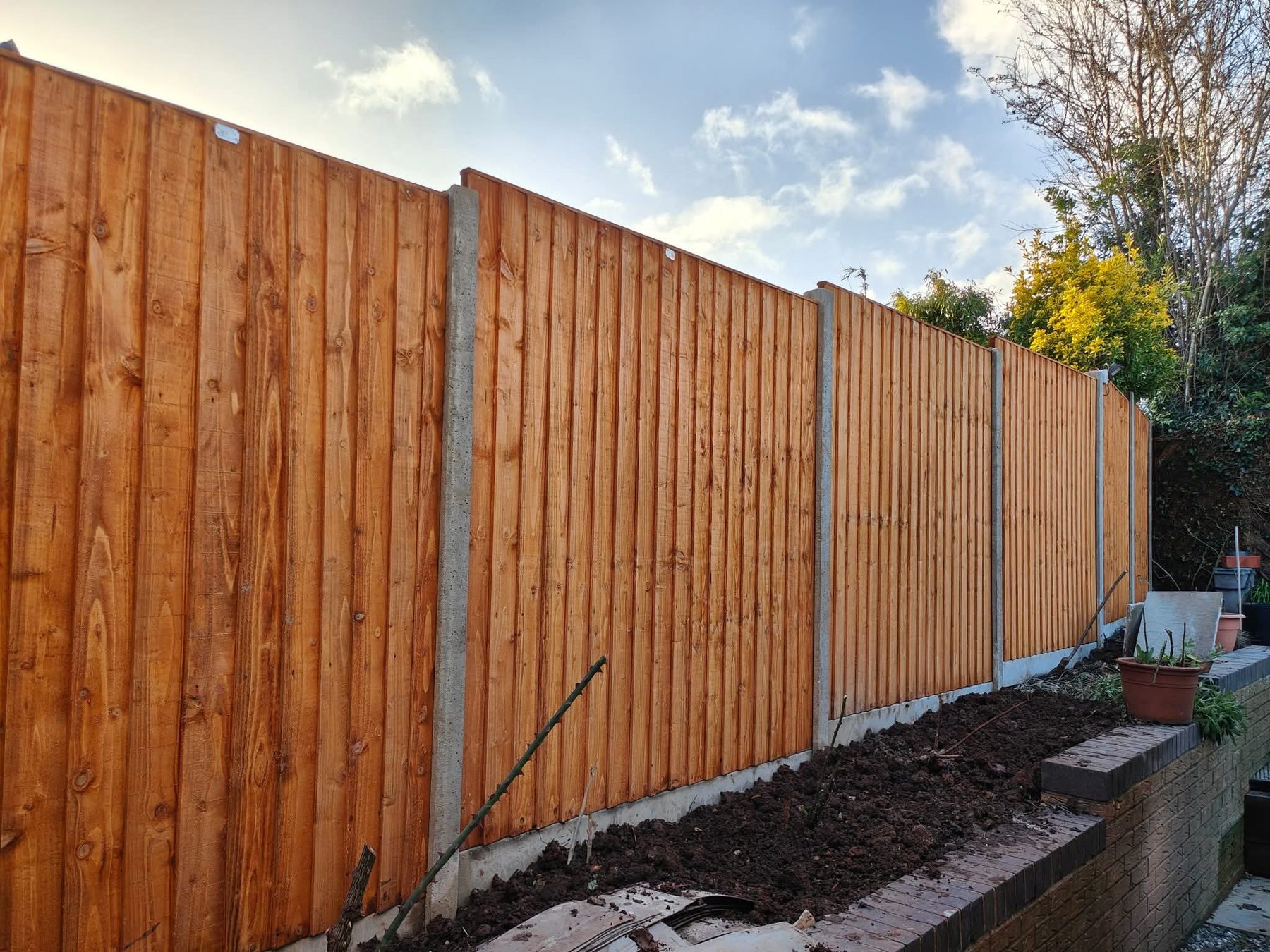 Completed stained garden fence