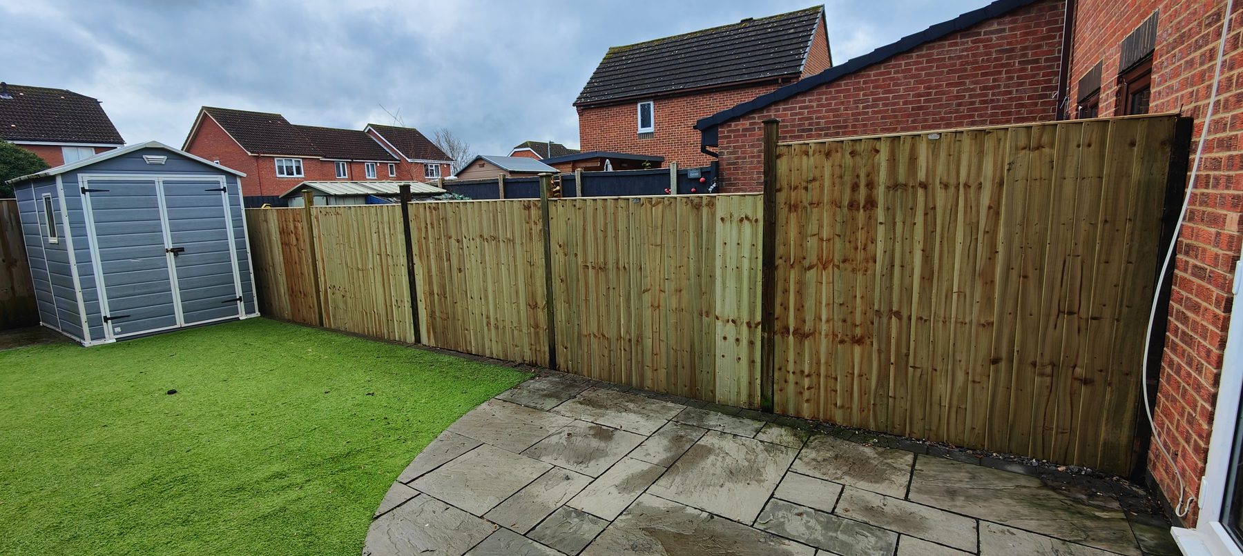 Fence beside patio and shed